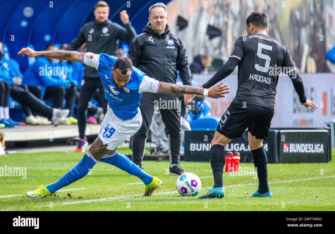 Rostock, Germany. 16th Mar, 2024. Soccer: Bundesliga 2, Hansa Rostock - SpVgg Greuther Fürth, Matchday 26, Ostseestadion. Rostock's Brumado Jr. (l) against Oussama Haddadi from Greuther Fürth. Credit: Jens Büttner/dpa - IMPORTANT NOTE: In accordance with the regulations of the DFL German Football League and the DFB German Football Association, it is prohibited to utilize or have utilized photographs taken in the stadium and/or of the match in the form of sequential images and/or video-like photo series./dpa/Alamy Live News Stock Photo