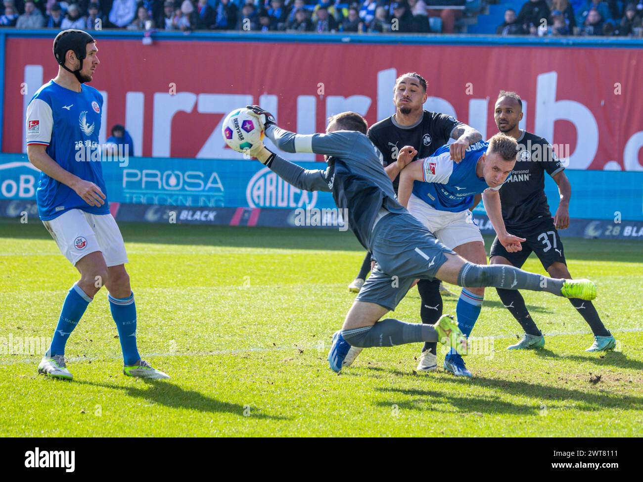 Rostock, Germany. 16th Mar, 2024. Soccer: Bundesliga 2, Hansa Rostock - SpVgg Greuther Fürth, Matchday 26, Ostseestadion. Rostock goalkeeper Markus Kolke holds a ball. Credit: Jens Büttner/dpa - IMPORTANT NOTE: In accordance with the regulations of the DFL German Football League and the DFB German Football Association, it is prohibited to utilize or have utilized photographs taken in the stadium and/or of the match in the form of sequential images and/or video-like photo series./dpa/Alamy Live News Stock Photo