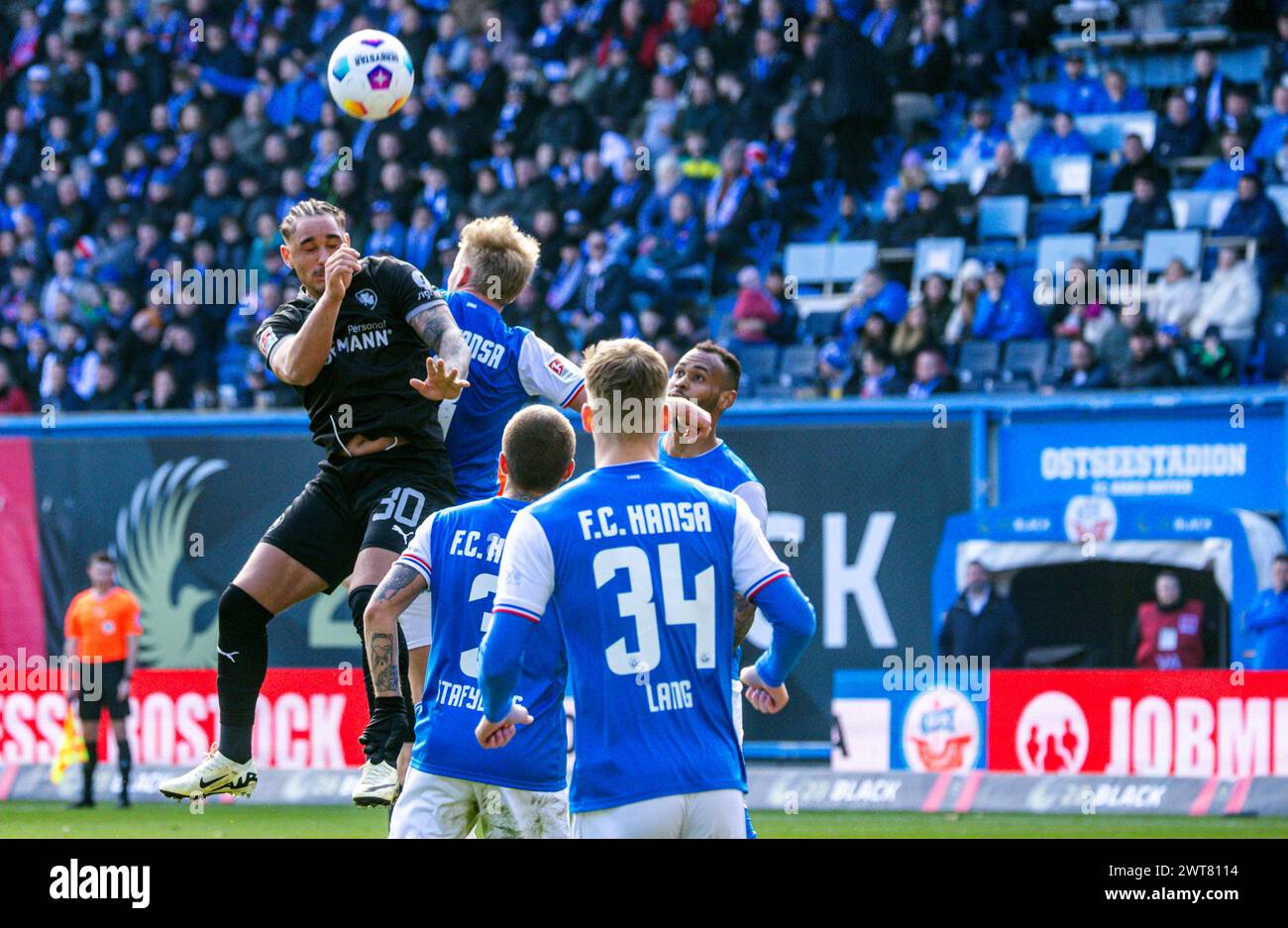 Rostock, Germany. 16th Mar, 2024. Soccer: Bundesliga 2, Hansa Rostock - SpVgg Greuther Fürth, Matchday 26, Ostseestadion. Armindo Sieb (l) of Greuther Fürth with a header against Rostock's Simon Rhein (r). Credit: Jens Büttner/dpa - IMPORTANT NOTE: In accordance with the regulations of the DFL German Football League and the DFB German Football Association, it is prohibited to utilize or have utilized photographs taken in the stadium and/or of the match in the form of sequential images and/or video-like photo series./dpa/Alamy Live News Stock Photo