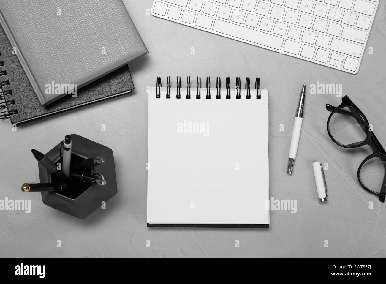 Flat lay composition with notebooks and glasses on light grey table Stock Photo