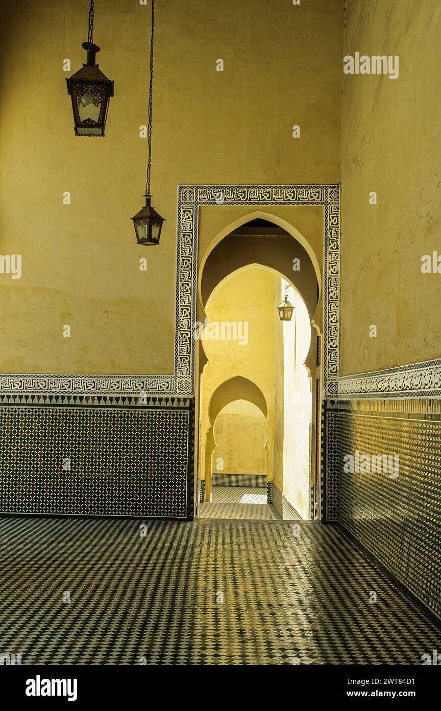 Meknes, Morocco.  Mausoleum of Moulay Ismail.  Horseshoe Arch Doorway.  The Arabic inscription in the frieze surrounding the doorway reads ''Auzu b'il Stock Photo