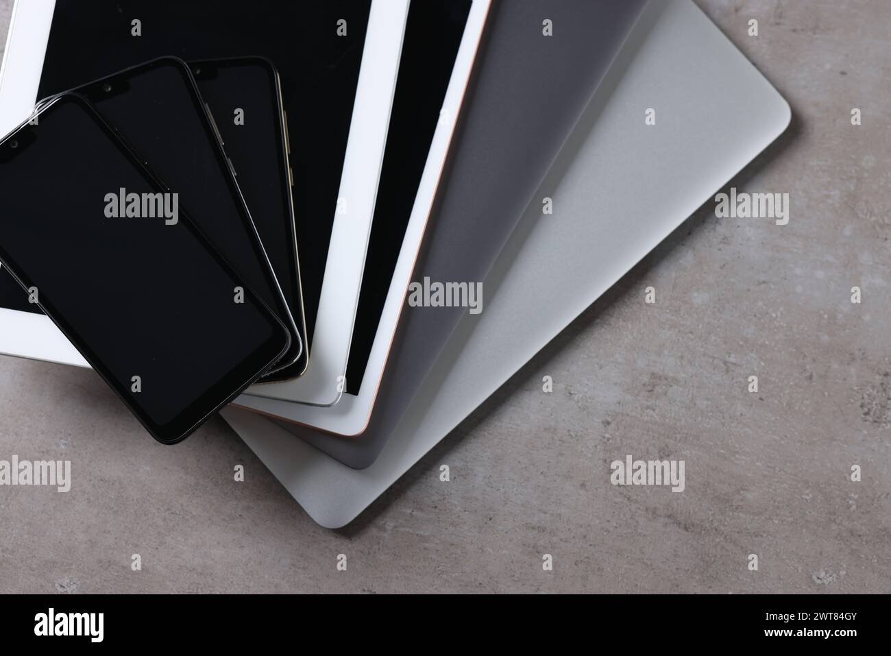 Many different modern gadgets on grey table, closeup Stock Photo