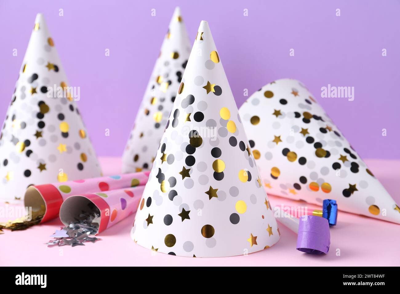 Party hats, confetti and blowers on color background Stock Photo - Alamy