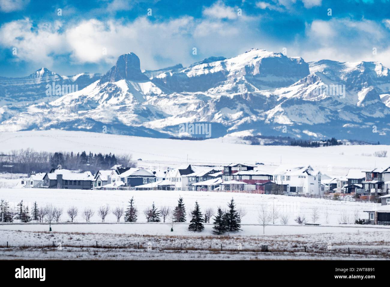 New community of Harmony overlooking farm fields and the Canadian Rocky Mountains West of the City of Calgary during winter. Stock Photo