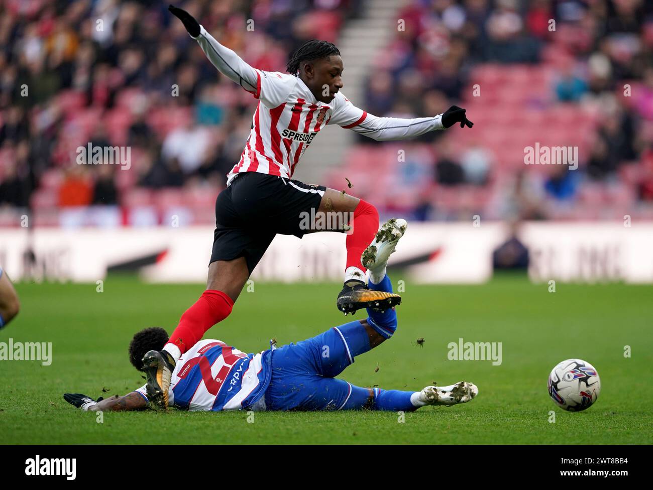 Queens Park Rangers' Kenneth Paal battles for the ball with Sunderland's Romaine Mundle during the Sky Bet Championship match at the Stadium of Light, Sunderland. Picture date: Saturday March 16, 2024. Stock Photo