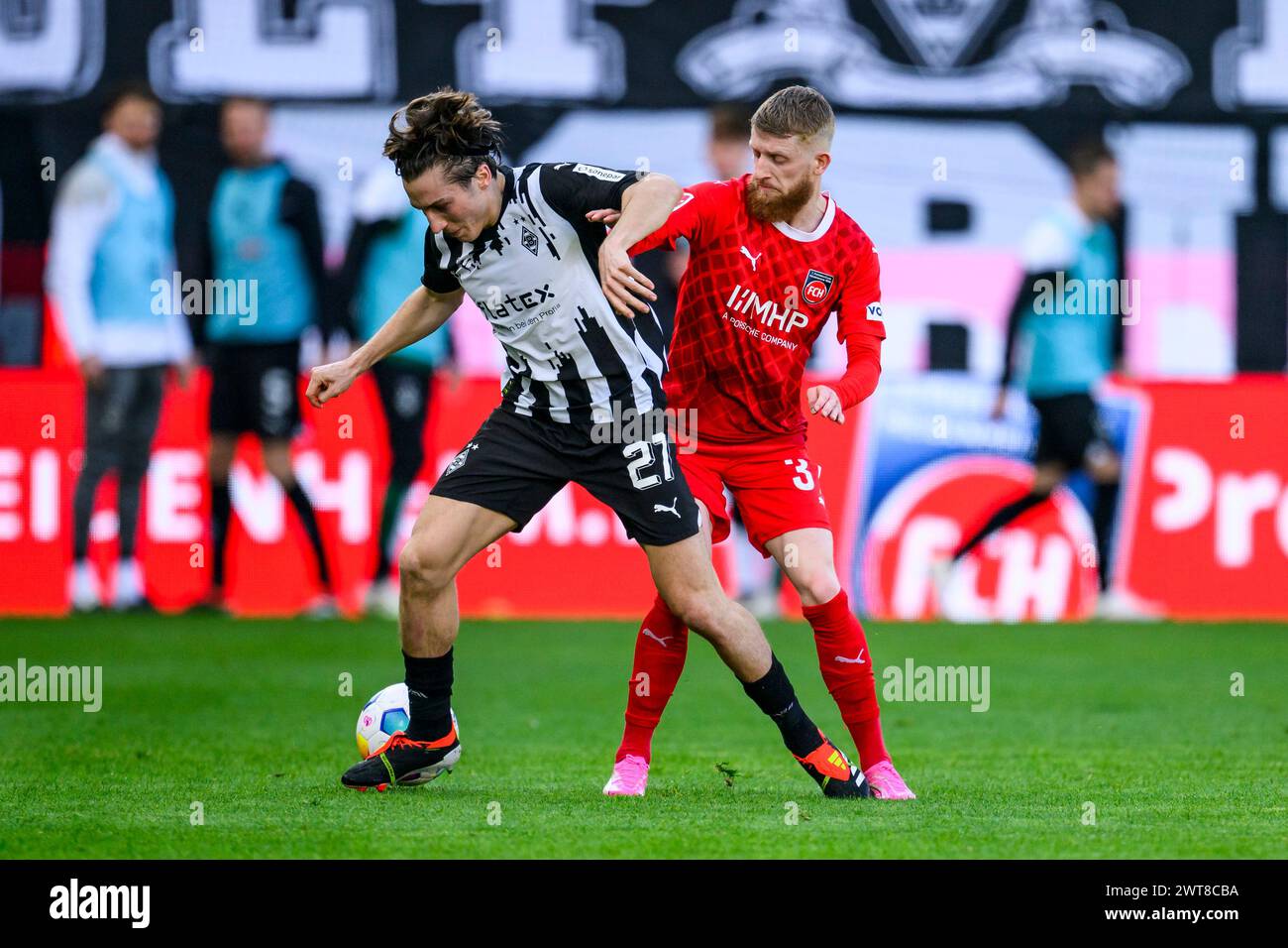 Heidenheim, Germany. 16th Mar, 2024. Soccer: Bundesliga, 1. FC Heidenheim - Borussia Mönchengladbach, Matchday 26, Voith-Arena. Heidenheim's Jan-Niklas Beste (r) in action against Gladbach's Rocco Reitz (l). Credit: Tom Weller/dpa - IMPORTANT NOTE: In accordance with the regulations of the DFL German Football League and the DFB German Football Association, it is prohibited to utilize or have utilized photographs taken in the stadium and/or of the match in the form of sequential images and/or video-like photo series./dpa/Alamy Live News Stock Photo