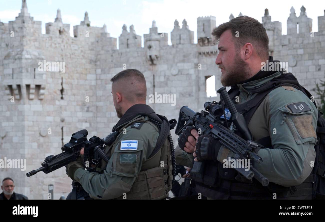 JERUSALEM - MARCH 15: Members of Israeli security forces stand guard outside Damascus gate as Muslim worshipers leave the temple mount after taking part in the first Friday prayer of the holy month of Ramadan on March 15, 2024 in Jerusalem. Israel Stock Photo