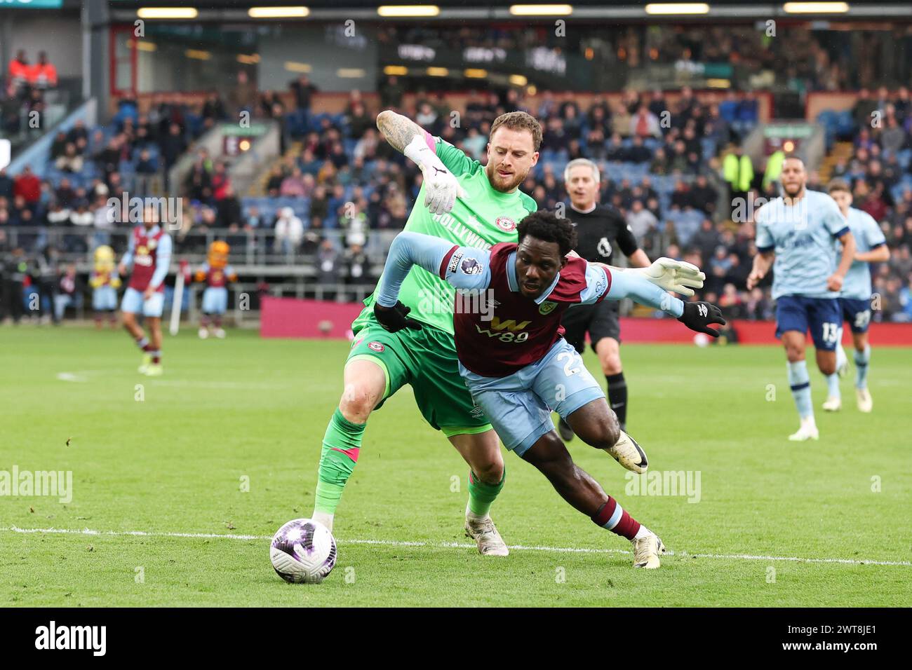 Burnley, UK. 16th Mar, 2024. Datro Fofana of Burnley takes the ball past Mark Flekken of Brentford during the Premier League match at Turf Moor, Burnley. Picture credit should read: Gary Oakley/Sportimage Credit: Sportimage Ltd/Alamy Live News Stock Photo
