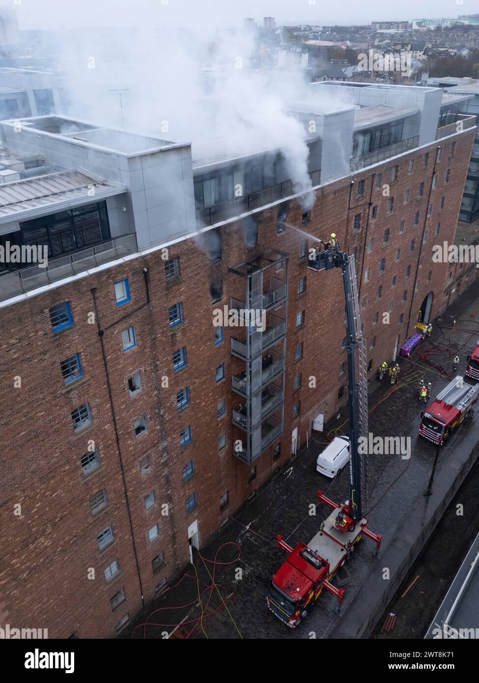 Edinburgh,  Scotland, UK. 14th March, 2024.  Aerial views of fire in apartment building at Breadalbane Street and Anderson Place in Leith, Edinburgh t Stock Photo