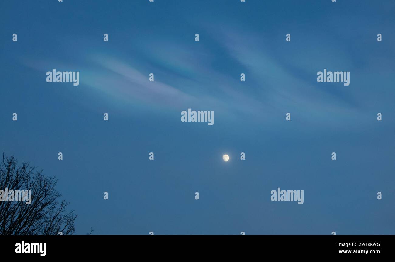 Moon and nacreous clouds Stock Photo