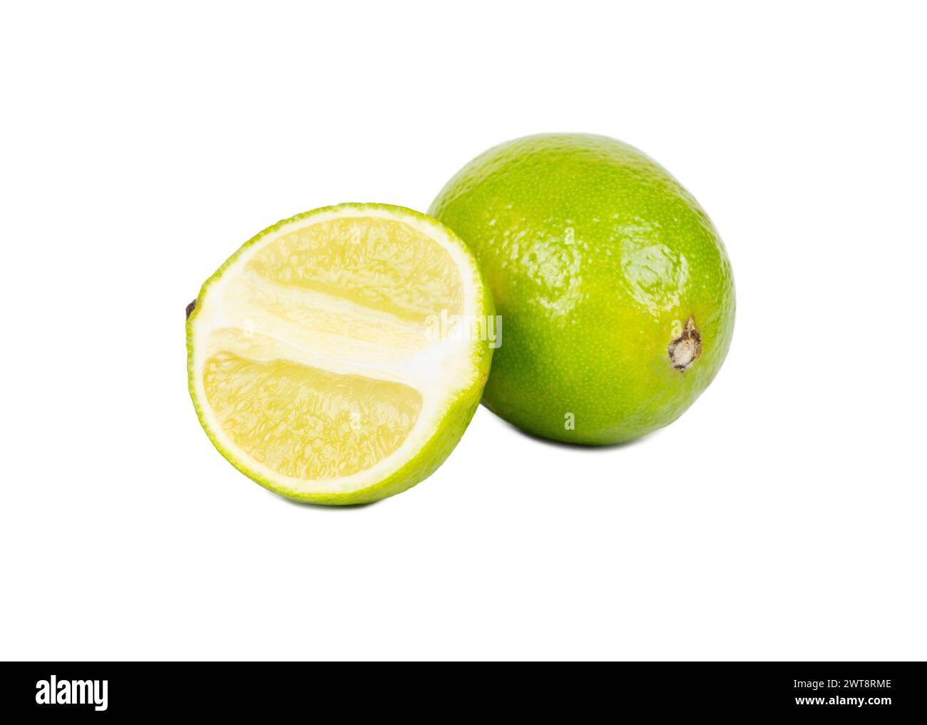 Fruit lime with juicy half isolated on white background Stock Photo