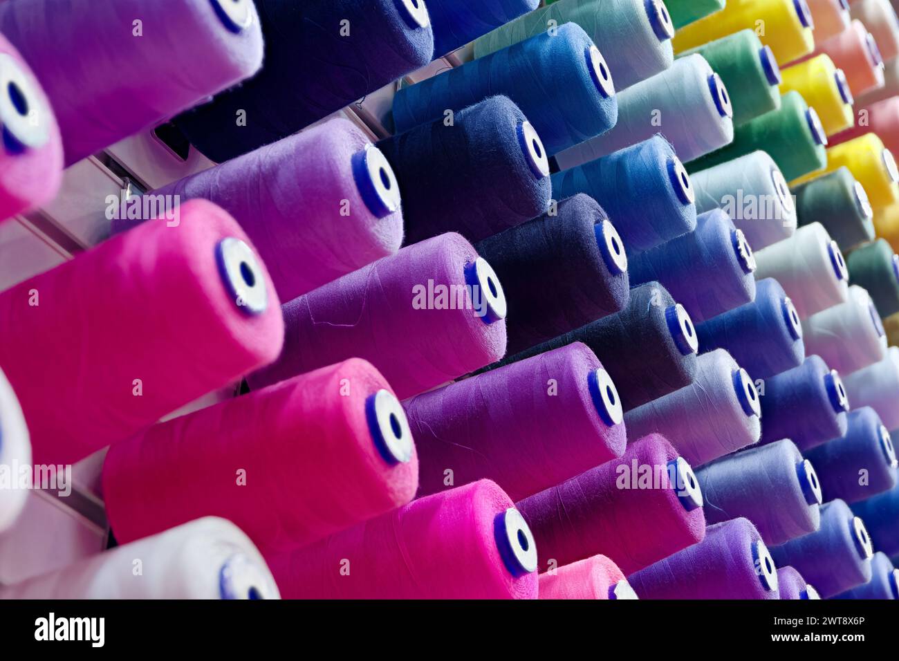 Assorted spools of multi-coloured cotton threads, abstract textile ...