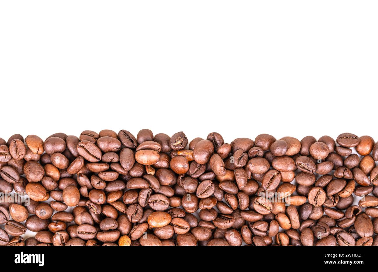 Scattered roasting coffee beans, top view, copy space Stock Photo