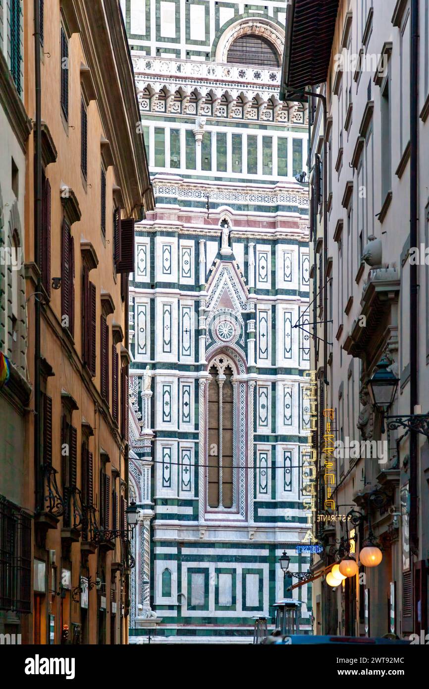 The famous Duomo (Cathedral) of Florence, Italy, a masterpiece of gothic style, completed in 1436 by Brunelleschi, as seen through the area buildings Stock Photo