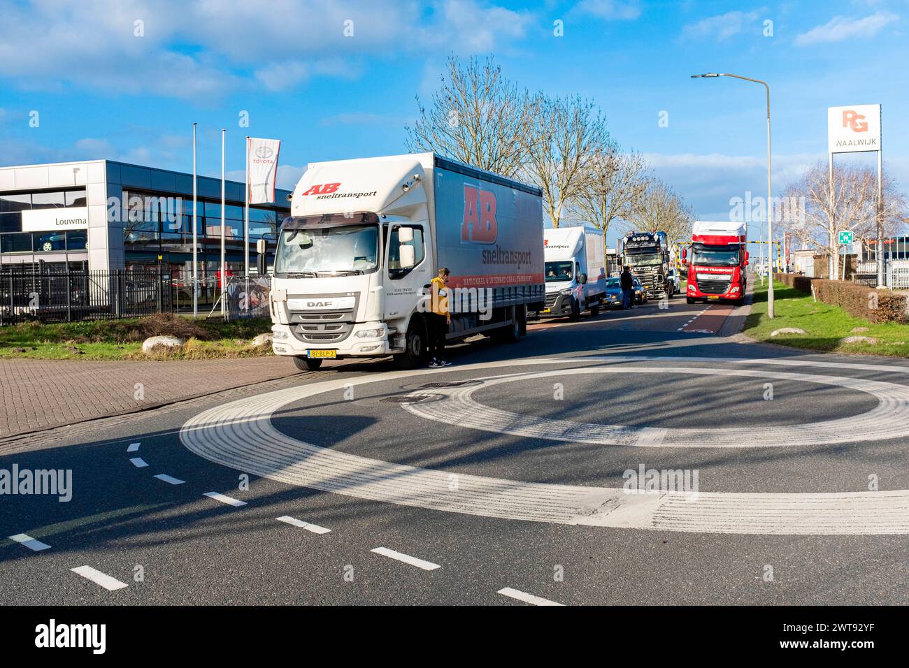 Truckers Convoy Assembling Waalwijk, Netherlands. On January 30, 2022 some regionally located trucks and truckers assemble on an Industrial Estate Road to connect to a trial run of the European Truckers Convoy towards Transportzone Hazeldonk near the Belgiuan Broder. Aim is to practise and gain momentum for the Main Convoy Run on Febrary 12, 2022. Waalwijk Industrie Terrein Noord-Brabant Nederland Copyright: xGuidoxKoppesx Stock Photo