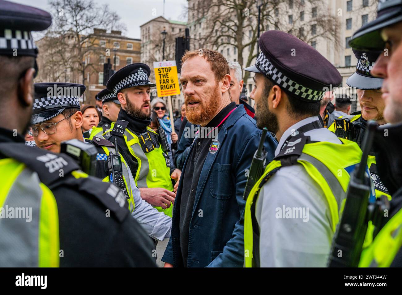 London, UK. 16th Mar, 2024. The pro Israel protester is led away by the police and released - Jeremy Corbyn MP speaks as a lone pro Israel protester infiltrates the front of the crowd (his placard say bring them home and against anti-semitism) - House against hate dance music ravve outside downing Street. A Stop Racism, Stop the Hate demonstration in London. Credit: Guy Bell/Alamy Live News Stock Photo