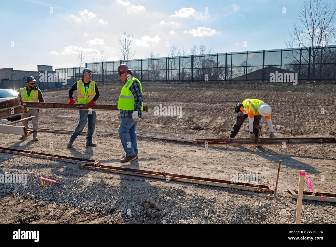 Detroit, Michigan - Workers build walkways on a section of the Joe Louis Greenway. When complete, the Greenway will be a 27.5-mile bicycle/walking tra Stock Photo