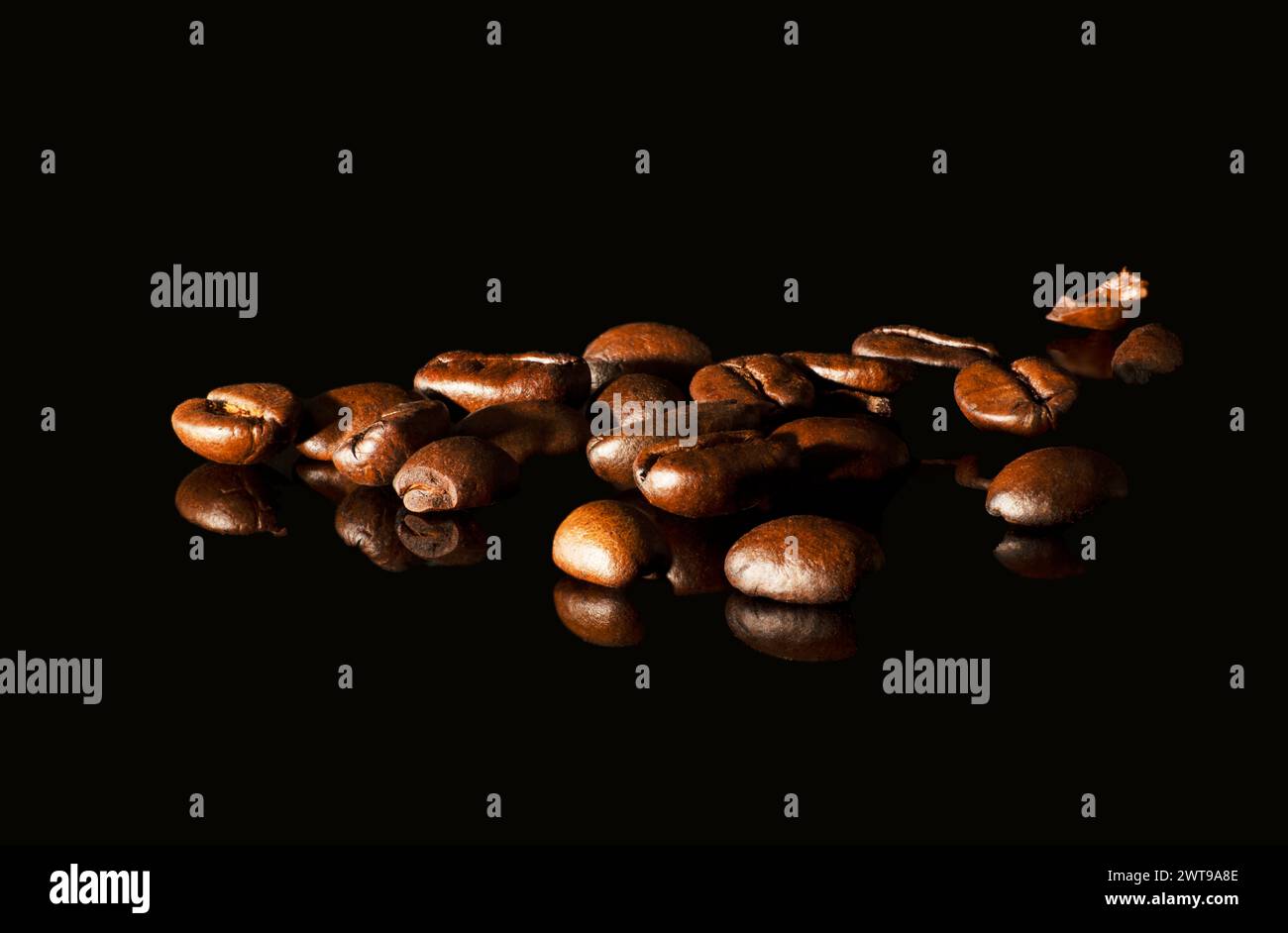 Aromatic coffee beans on black glass background Stock Photo - Alamy