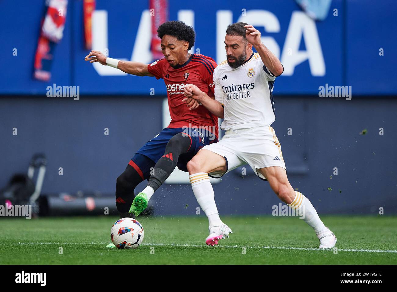 Daniel Carvajal of Real Madrid CF compete for the ball with Johan Mojica of CA Osasuna during the LaLiga EA Sports match between CA Osasuna and Real Madrid CF at El Sadar Stadium on March 16, 2024, in Pamplona, Spain. Credit: Cesar Ortiz Gonzalez/Alamy Live News Stock Photo
