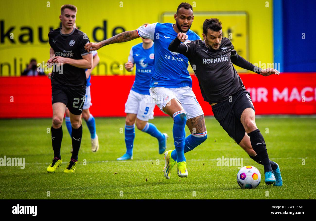 Rostock, Germany. 16th Mar, 2024. Soccer: Bundesliga 2, Hansa Rostock - SpVgg Greuther Fürth, Matchday 26, Ostseestadion. Oussama Haddadi (r) of Greuther Fürth against Rostock's Brumado Jr. (l). Credit: Jens Büttner/dpa - IMPORTANT NOTE: In accordance with the regulations of the DFL German Football League and the DFB German Football Association, it is prohibited to utilize or have utilized photographs taken in the stadium and/or of the match in the form of sequential images and/or video-like photo series./dpa/Alamy Live News Stock Photo