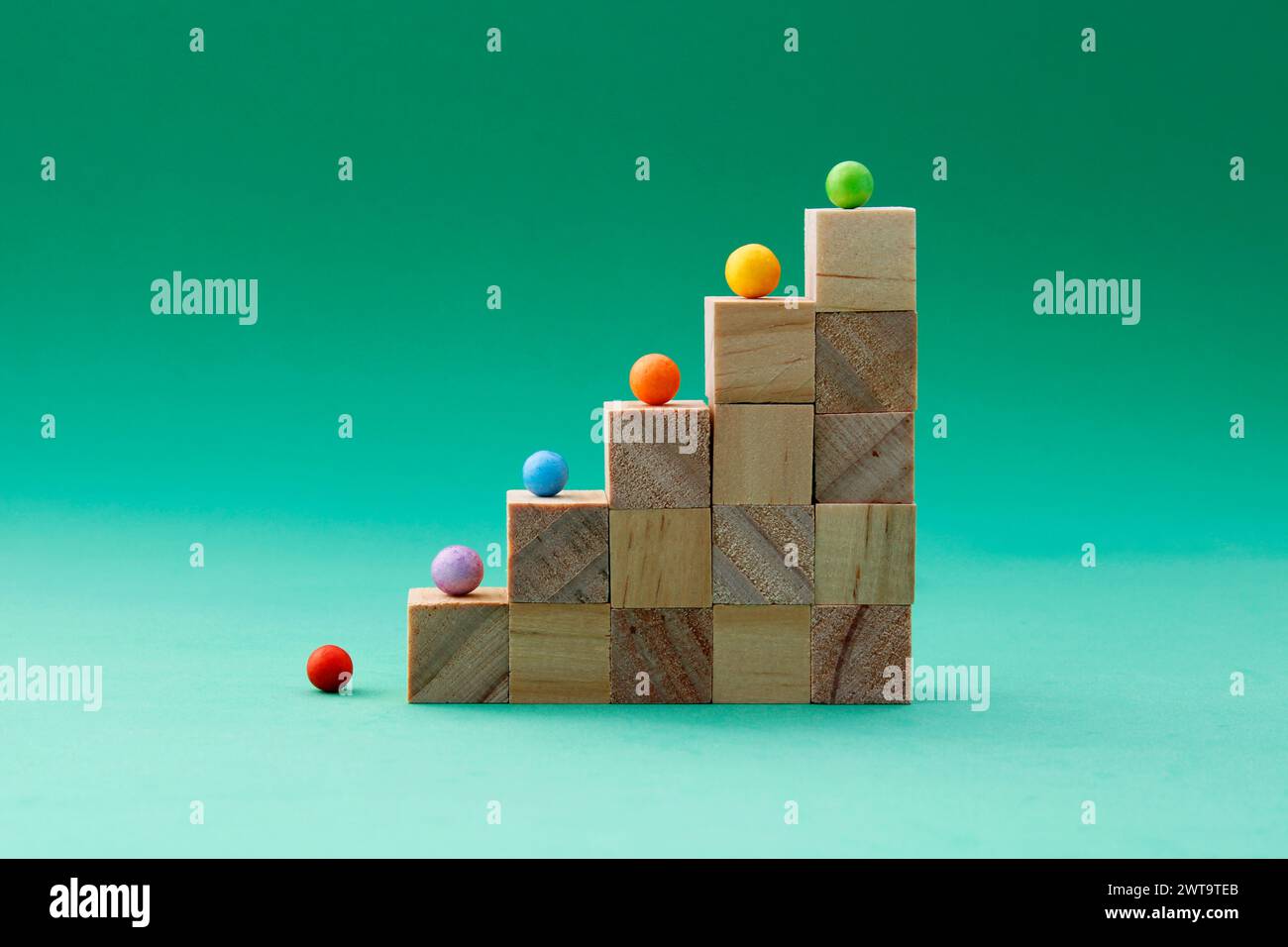 Wooden cubes forming a staircase with a different colored sphere on ...