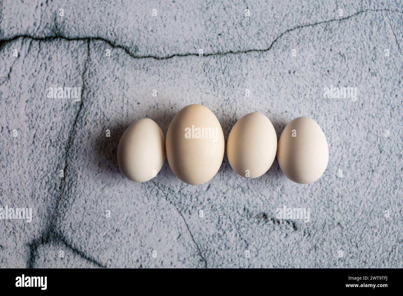 Four white eggs on an empty background. Easter concept Stock Photo