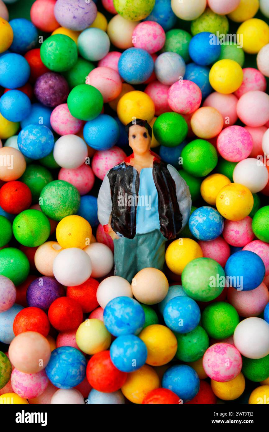 Man on many spheres of different colors Stock Photo