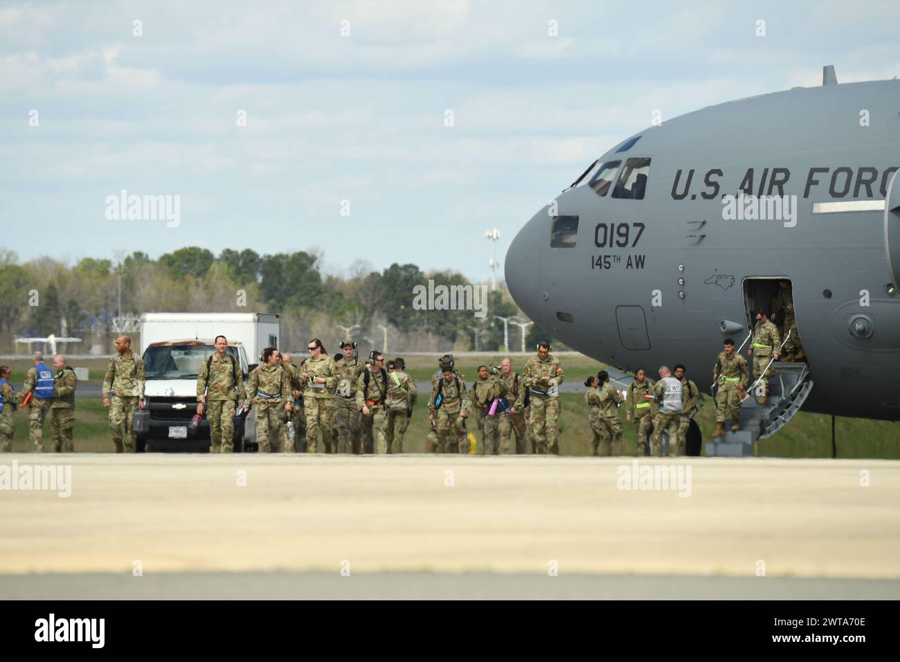 North Carolina Air National Guardsmen depart a C-17 Globemaster III aircraft following its landing during a readiness exercise at the Charlotte-Douglas International Airport base, Mar. 16, 2024. The readiness exercise demonstrates agile combat employment with multi-capable Airmen. (U.S. Air National Guard photo by Tech. Sgt. Laura J. Tickle) Stock Photo