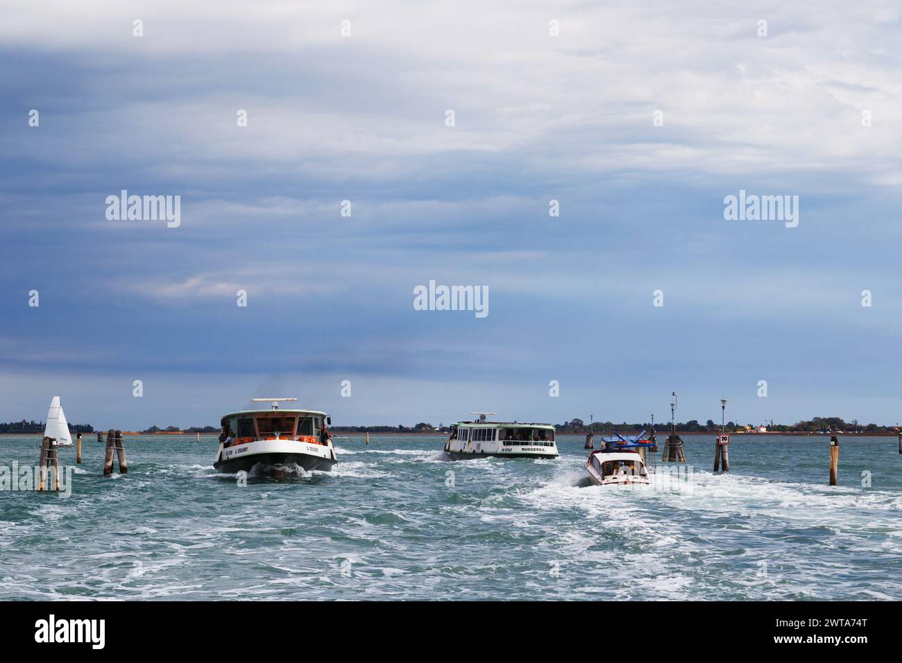 Venice, Italy - October, 6 2019: Vaporetti or Venetian public water buses and water taxi. Public transport route, city's traffic in Venice, Italy. Stock Photo