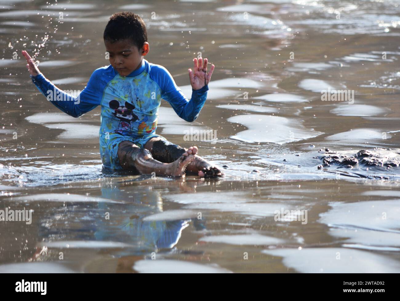 Children enjoying playing in ocean at Playa Hermosa, Costa Rica Stock Photo