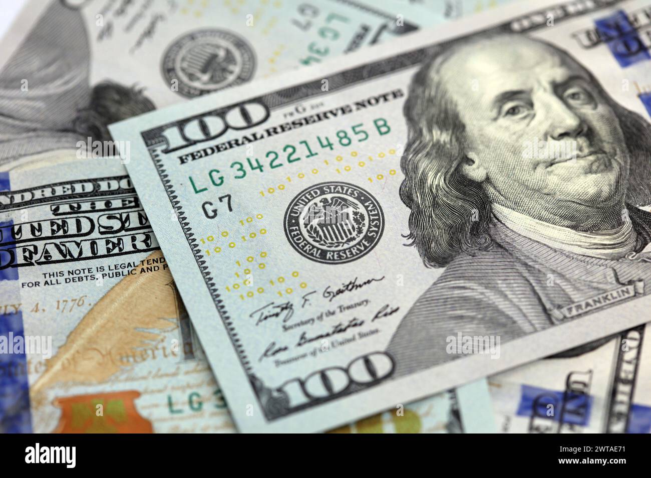 American one hundred dollar notes. Shallow depth of field focus on federal reserve. Angled shot with no complete notes shown. Stock Photo