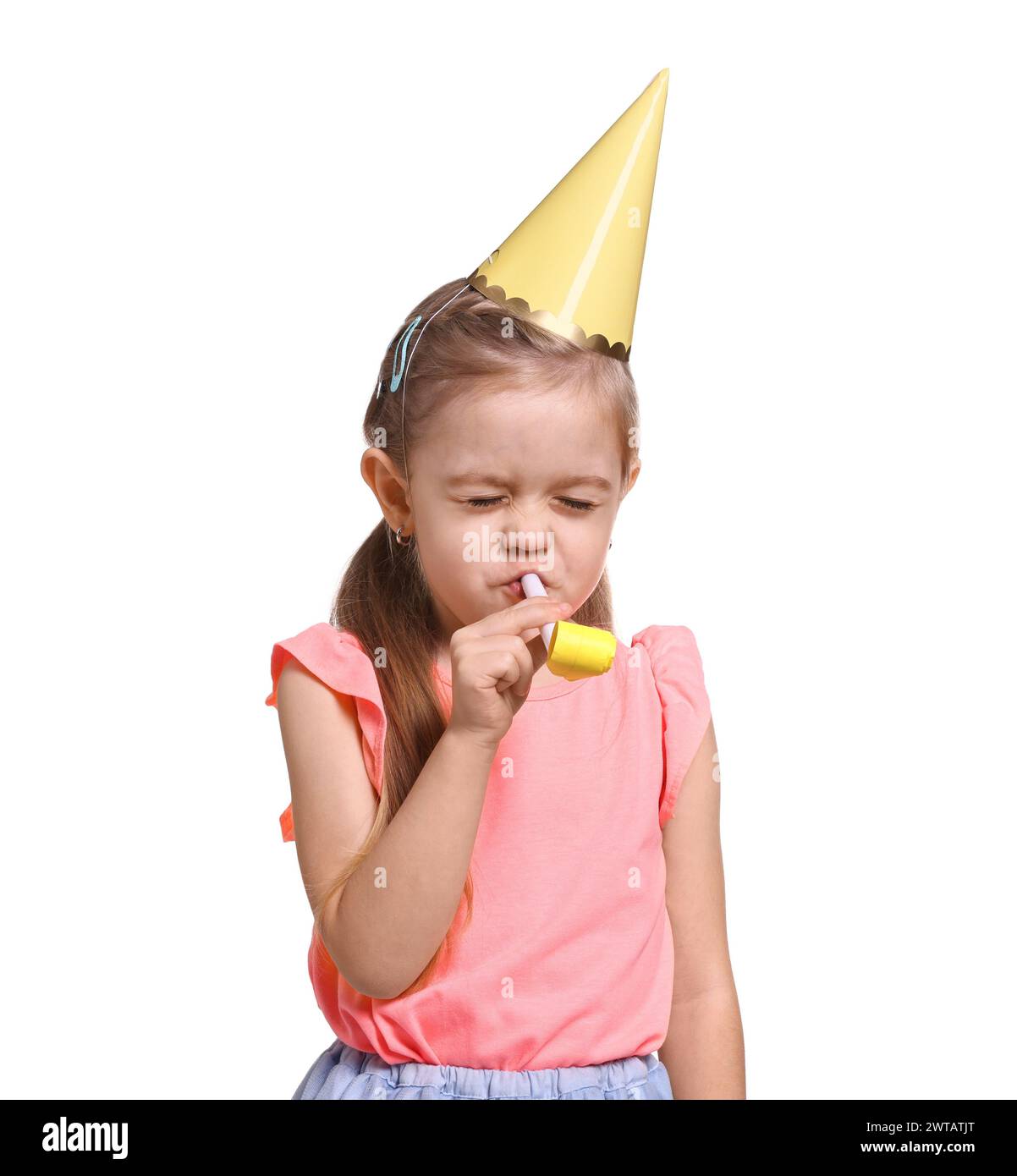 Birthday celebration. Cute little girl in party hat with blower on ...