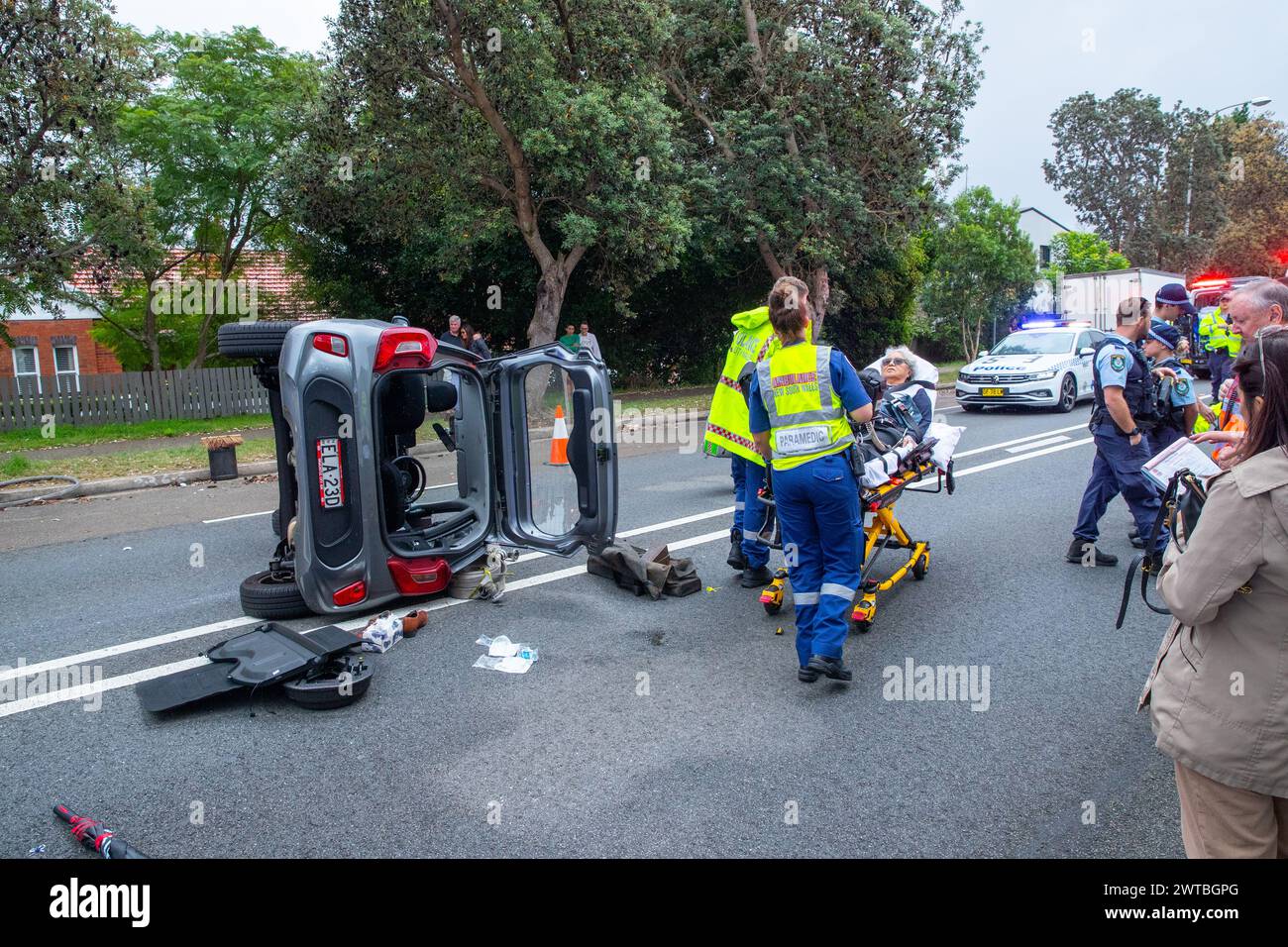 Sydney, Australia. 17 Mar 2024. A dramatic single vehicle accident has occurred on Carrington Road in Waverley in Sydney's Eastern Suburbs after an elderly female driver's car connected with a sloped abutment that sent her car toppling on its side. She was transported to hospital by ambulance workers. The abutment was part of a construction site that has been tasked with the de-construction of Waverley Communication Tower. Stock Photo