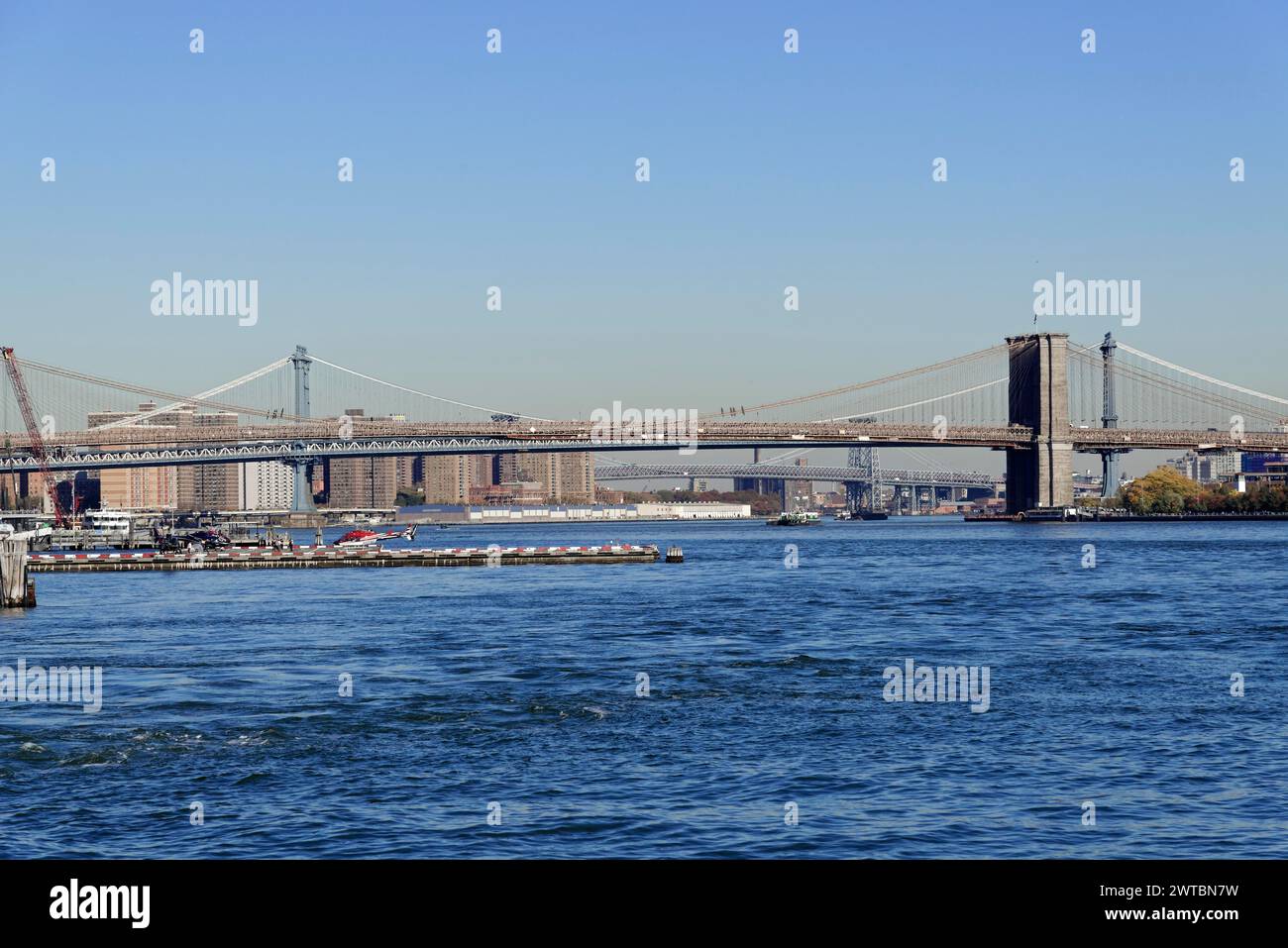 View of a bridge over a river with ships and clear blue sky, downtown Manhattan, Manhattan, New York City, USA, North America Stock Photo