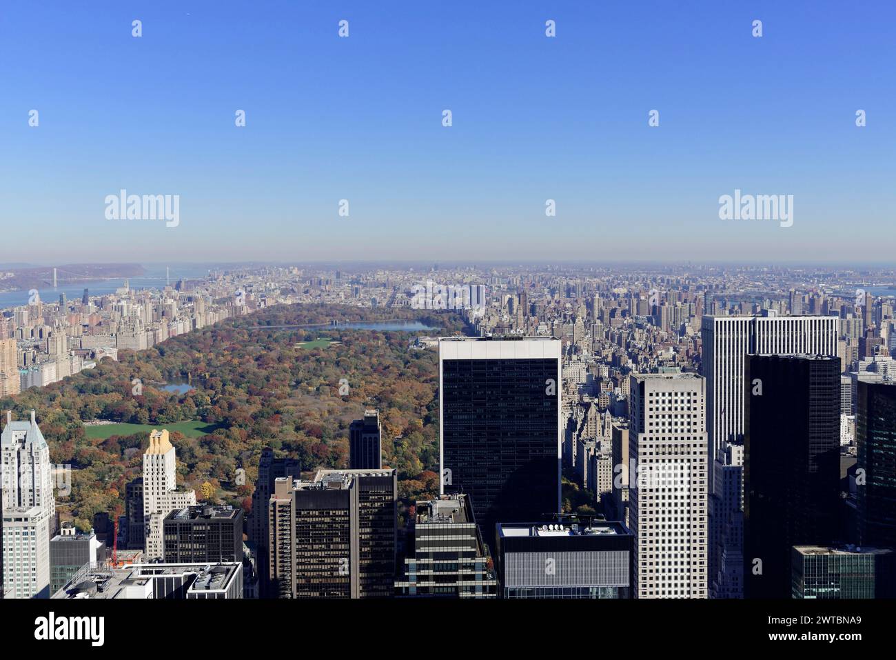 Rockefeller Center observation deck, view of skyscrapers in front of Central Park with autumn trees under clear blue sky, Manhattan, New York City Stock Photo