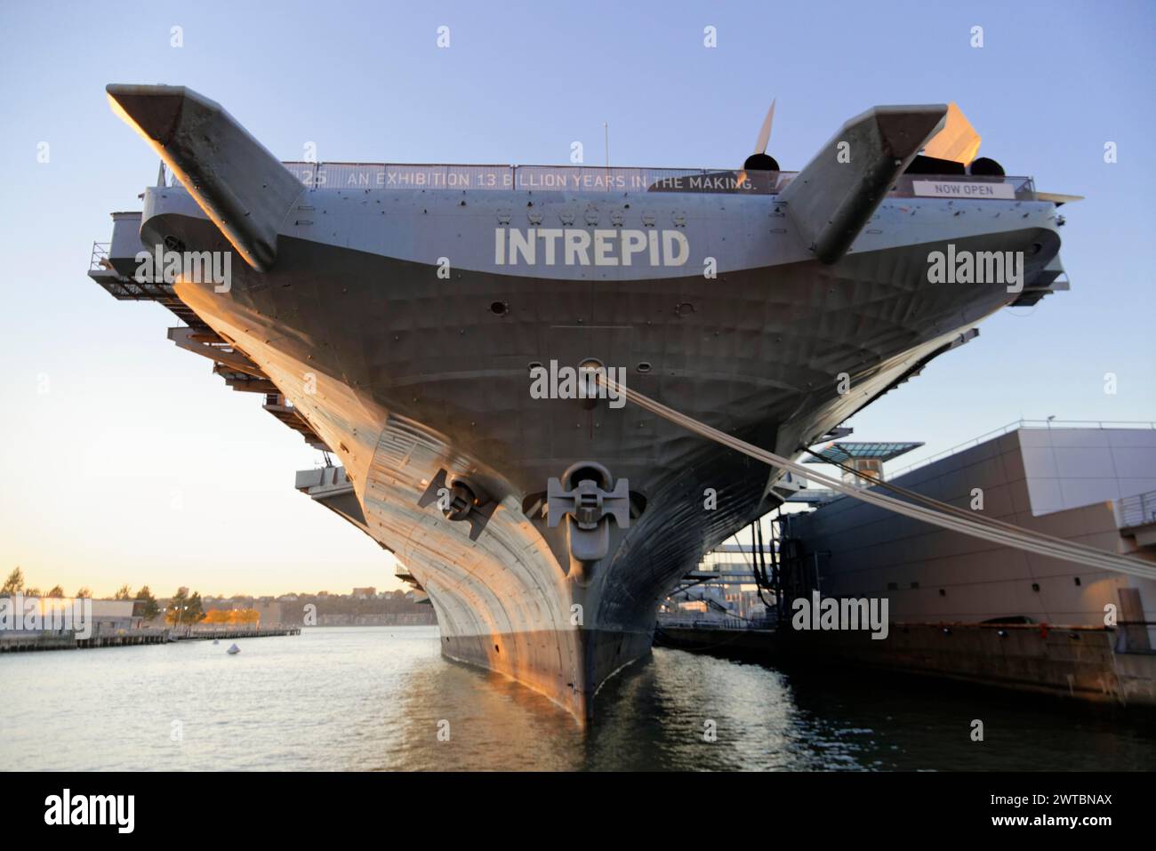 The front view of the museum ship Intrepid, a decommissioned aircraft carrier, in the water, on the East River, Manhattan, Brooklyn, New York City Stock Photo