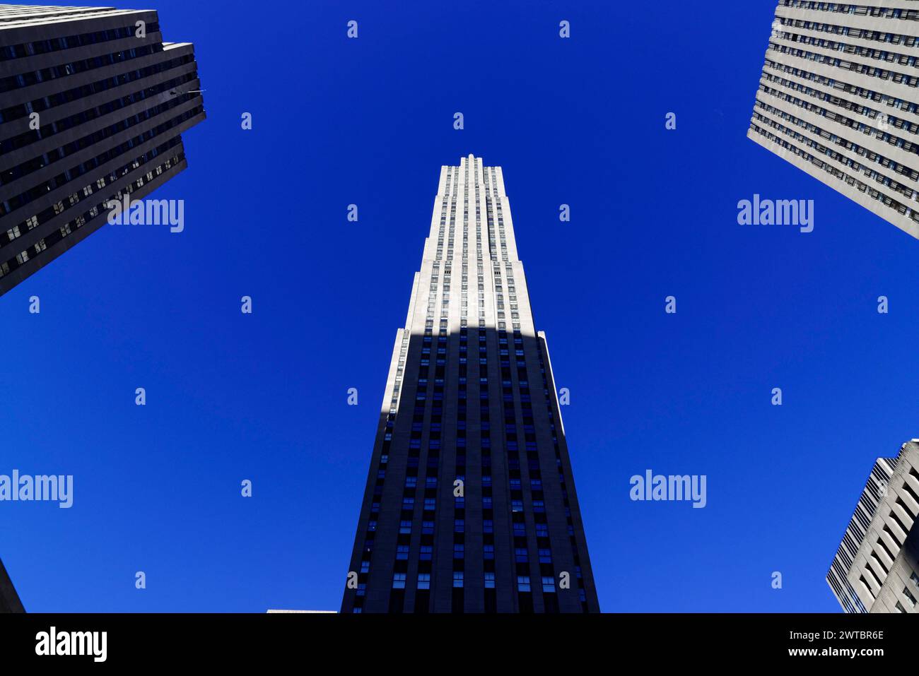 View of the tall Rockefeller Center against a clear blue sky surrounded by other buildings, Manhattan, Brooklyn, New York City, New York, USA, North Stock Photo