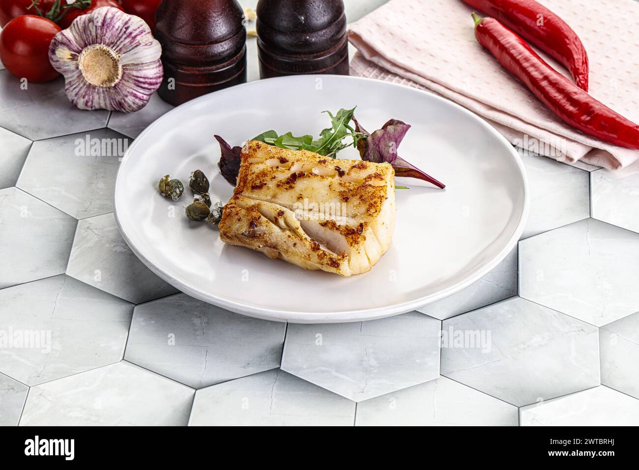 Roasted cod fish steak with salad leaves Stock Photo - Alamy