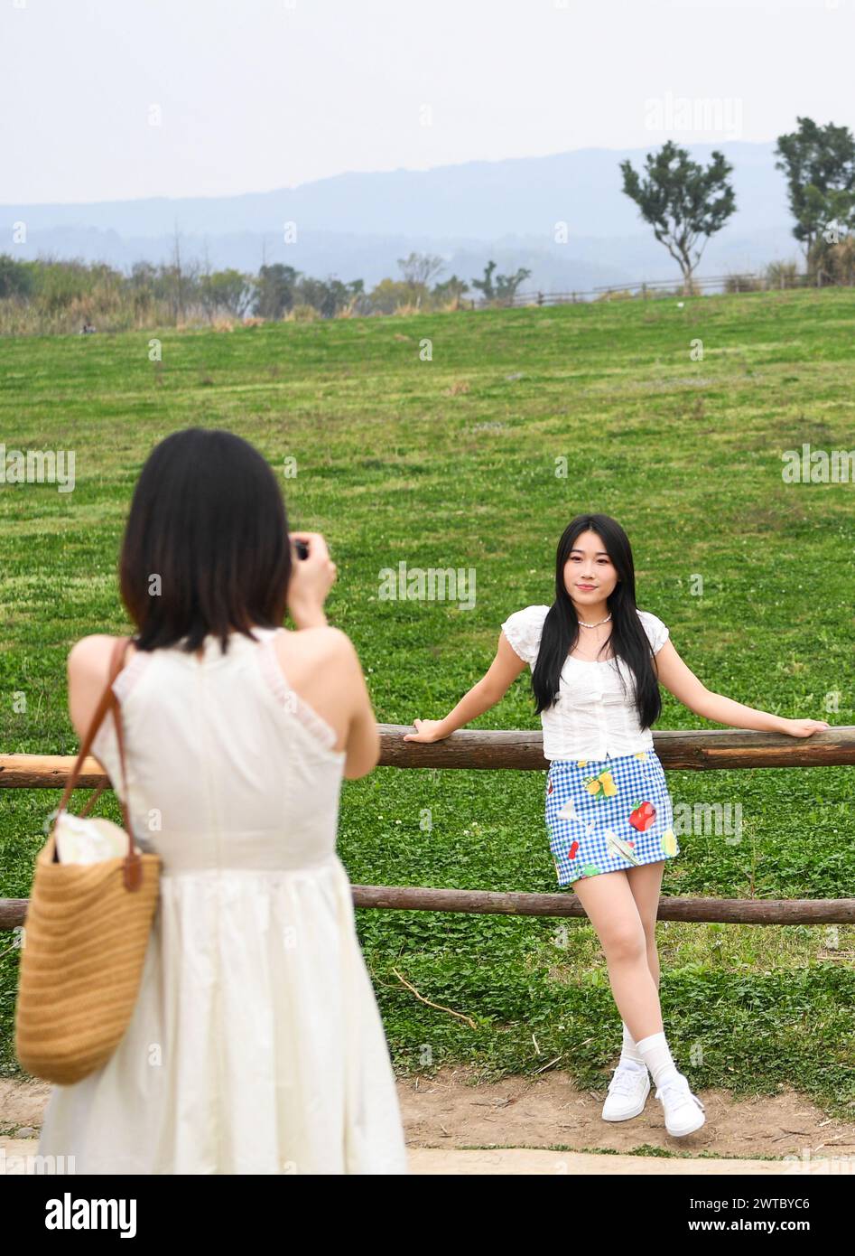 (240317) -- CHONGQING, March 17, 2024 (Xinhua) -- Tourists take photos at Guangyang Isle in southwest China's Chongqing, March 16, 2024. Guangyang Isle, the most extensive green island in the upper reaches of the Yangtze River, has been turned into an ecological restoration and protection 'classroom' for ecotourists and school children.The local ecosystem and biodiversity were once seriously threatened due to real-estate projects in the area. However, the local government brought harmful projects of this sort to a halt in 2017, starting the restoration of the environment on the island. (Xinhua Stock Photo