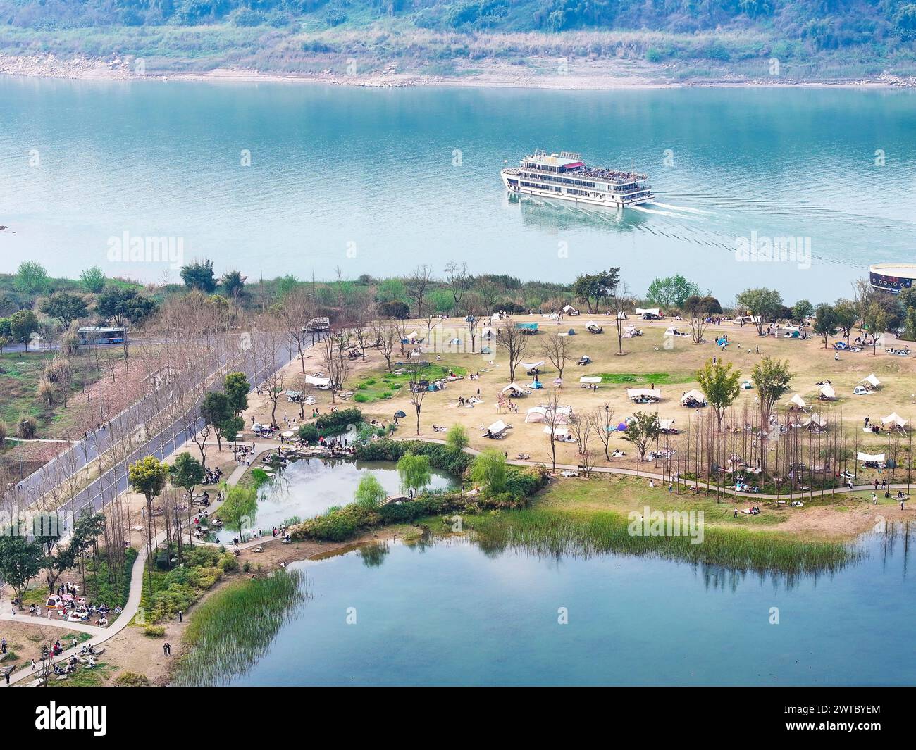 (240317) -- CHONGQING, March 17, 2024 (Xinhua) -- An aerial drone photo shows a view of Guangyang Isle in southwest China's Chongqing, March 16, 2024. Guangyang Isle, the most extensive green island in the upper reaches of the Yangtze River, has been turned into an ecological restoration and protection 'classroom' for ecotourists and school children.The local ecosystem and biodiversity were once seriously threatened due to real-estate projects in the area. However, the local government brought harmful projects of this sort to a halt in 2017, starting the restoration of the environment on the i Stock Photo