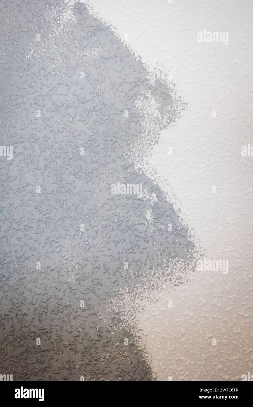 grey painted woodchip wallpaper texture pattern backgroung. Stock Photo