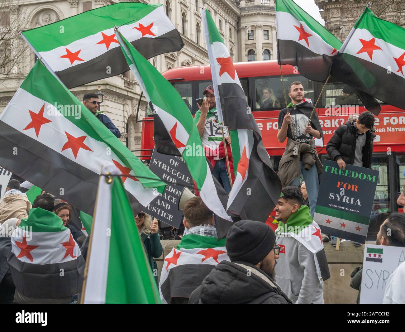London, UK. 16 March 2024.  Syrians protest at Downing St on the 13th Anniversary of the Syrian Revolution. More than half of Syria's population have been displaced with millions fleeing the country as the Asdsad regime has committed unspeakable atrocities against the people of Syria, who rose up peacefully for democracy, reforms, and accountability. They called on everyone to remember those many Syrians who have been killed and to continue to support the demands for democracy, reforms and accountability. Peter Marshall/Alamy Live News Stock Photo