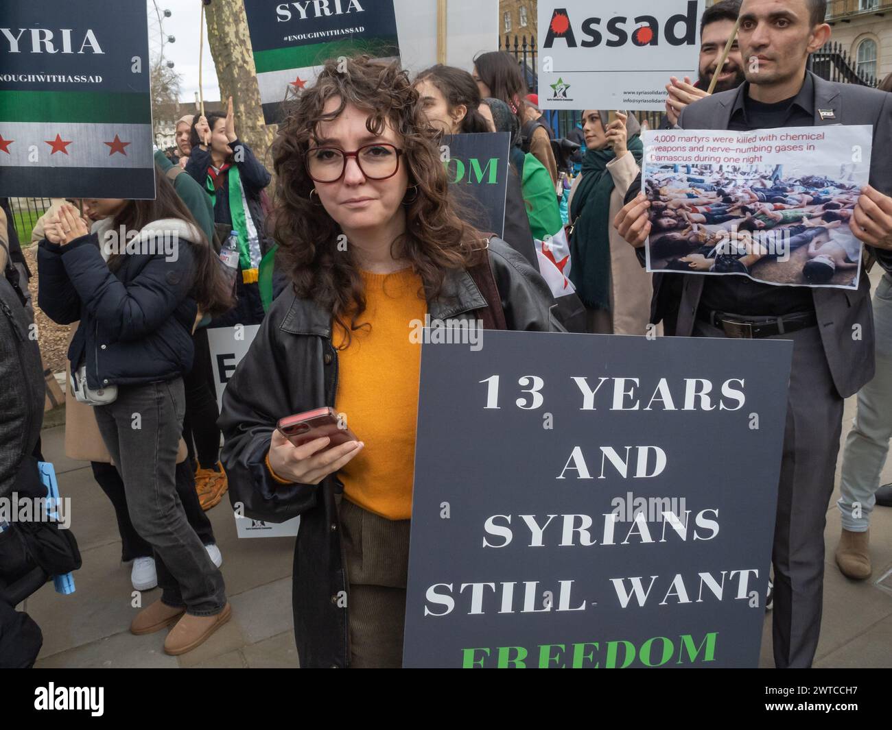 London, UK. 16 March 2024.  Syrians protest at Downing St on the 13th Anniversary of the Syrian Revolution. More than half of Syria's population have been displaced with millions fleeing the country as the Asdsad regime has committed unspeakable atrocities against the people of Syria, who rose up peacefully for democracy, reforms, and accountability. They called on everyone to remember those many Syrians who have been killed and to continue to support the demands for democracy, reforms and accountability. Peter Marshall/Alamy Live News Stock Photo