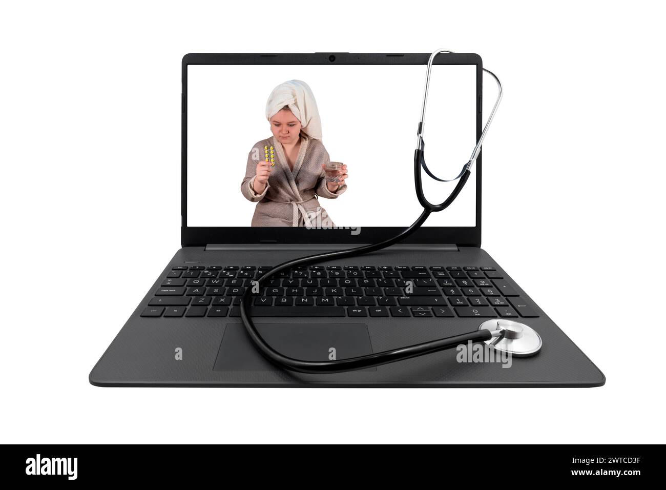 Laptop and stethoscope isolated on white background. On the laptop screen - a girl with cold symptoms holds a blister with pills and a glass of water Stock Photo