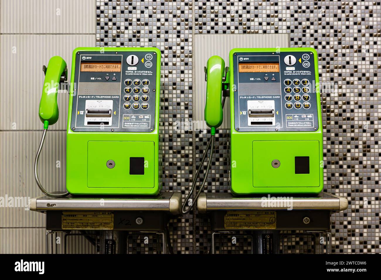 Two Green Japanese Payphones Side by Side in Tokyo Japan Stock Photo