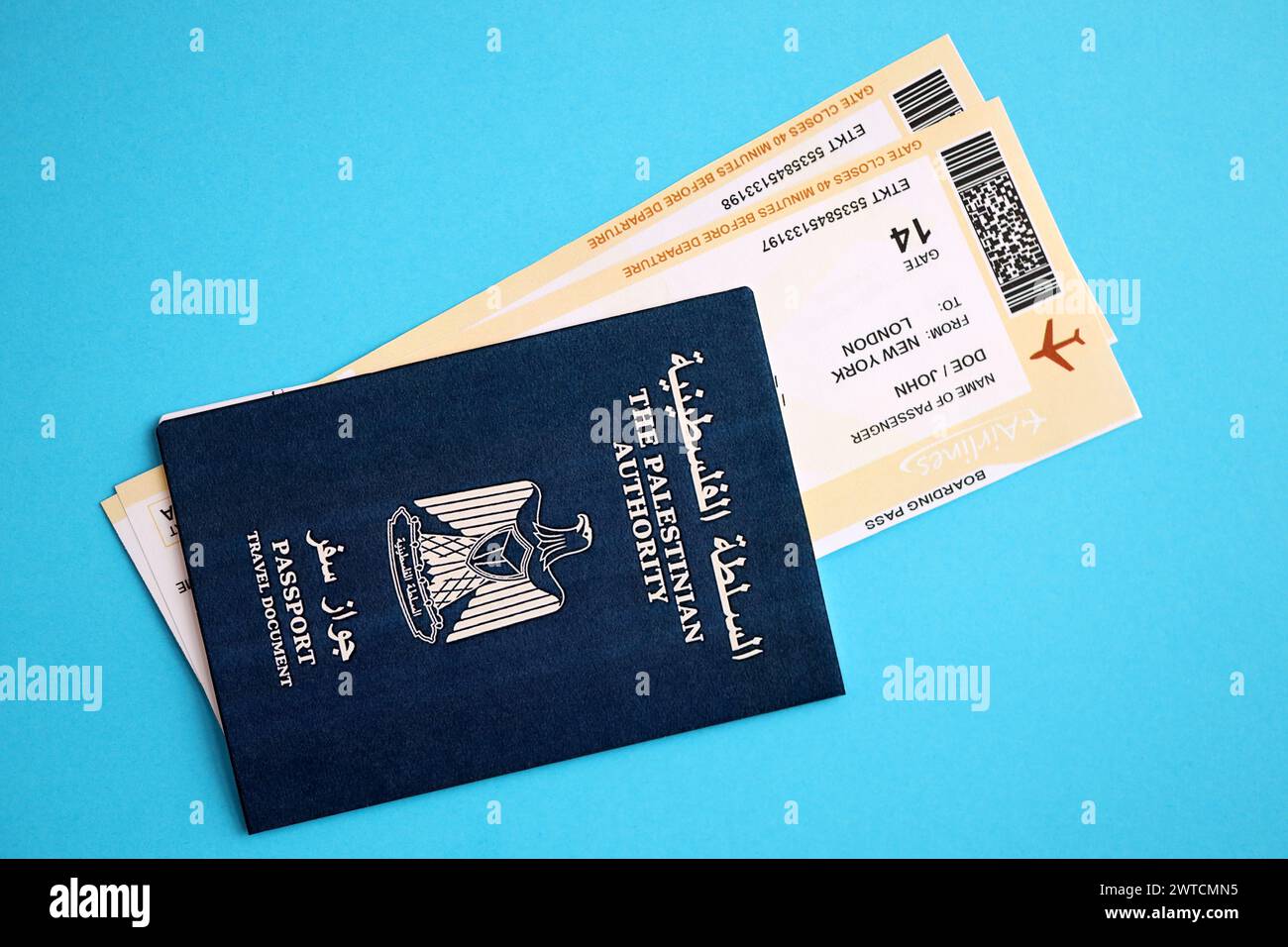 Blue Palestinian Authority passport with airline tickets on blue