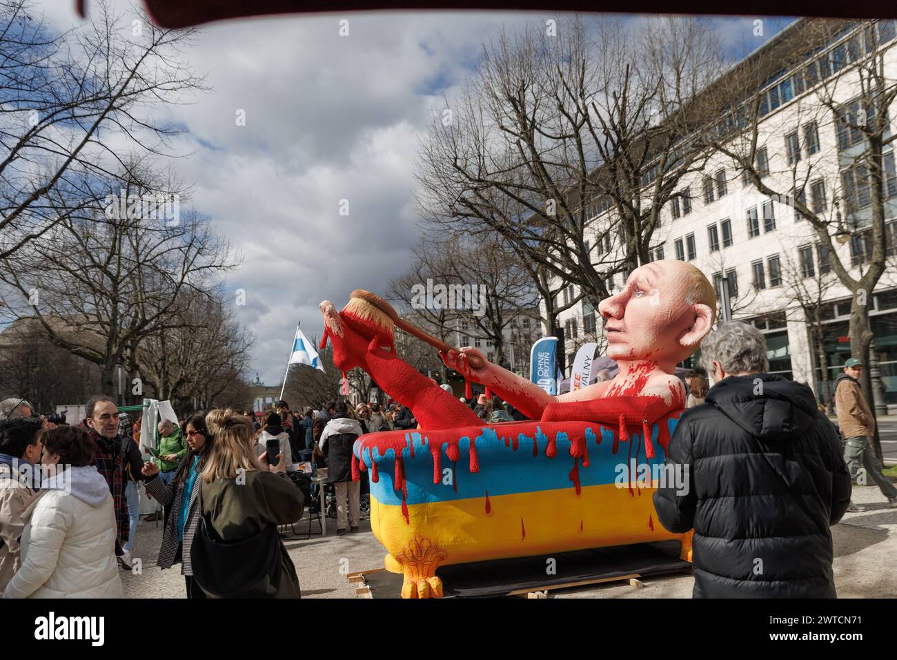 Berlin, Germany. 17th Mar, 2024. A figure depicting Russian President Putin in a bathtub stands at a rally. Participants in a demonstration 'Stop Putin, war, lies and repression' organized by the alliance 'Democracy - Yes' protest against President Putin's policies, lies and repression in Russia in front of the Russian Embassy one month after the death of Kremlin critic Navalny. Credit: Carsten Koall/dpa/Alamy Live News Stock Photo