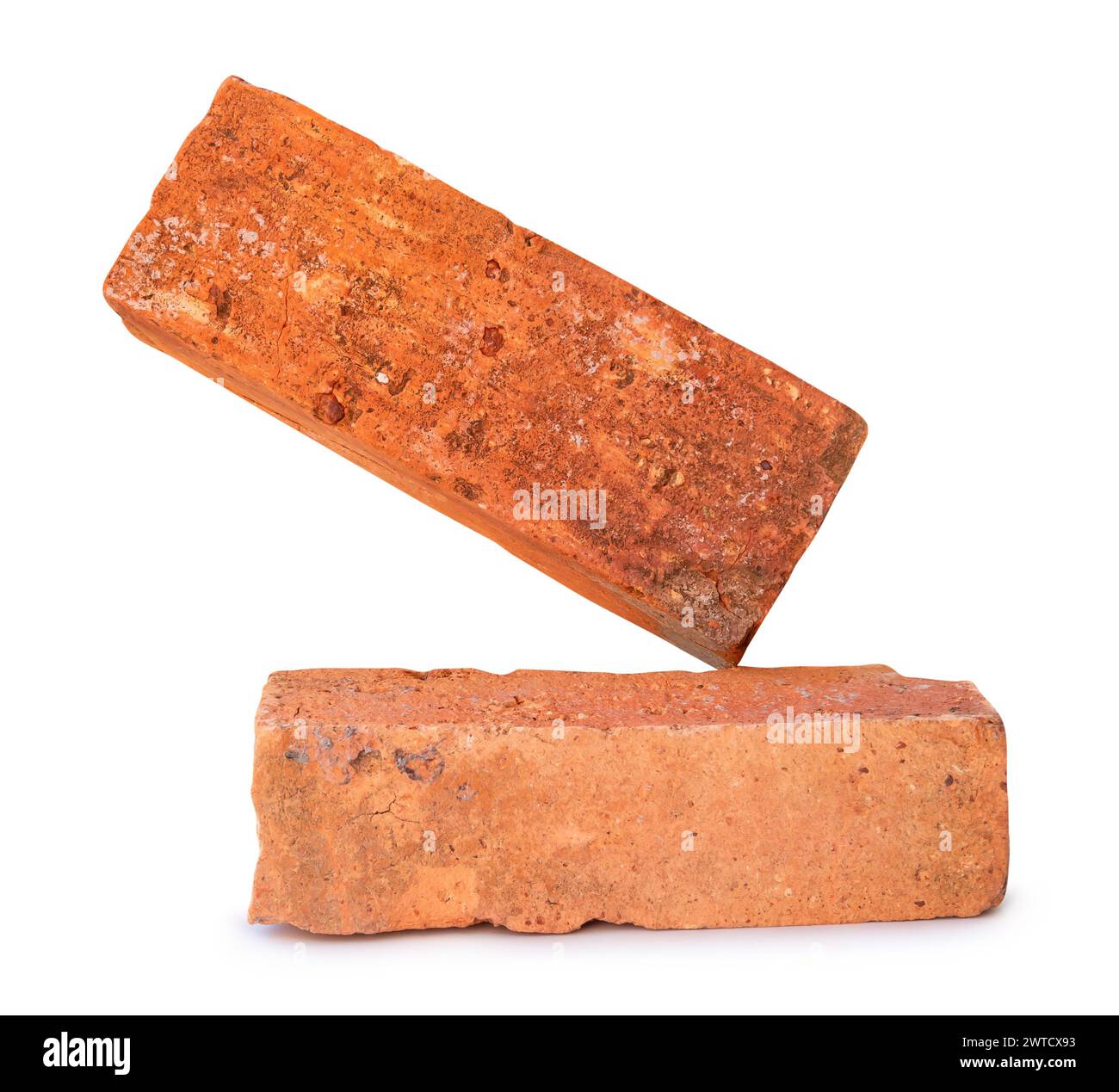 Side view of cracked old red or orange bricks in stack is isolated on white background with clipping path. Stock Photo