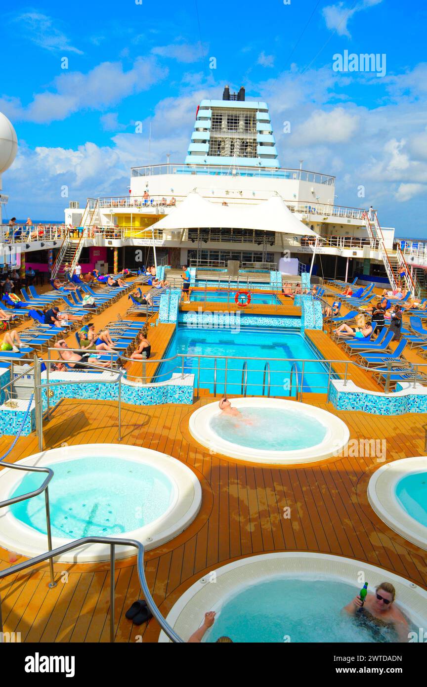 Marella Explorer, ship, in the Caribbean, sea with swimming pools, spars, on the top deck. There are tourists, and, passengers, outdoor, relaxing Stock Photo