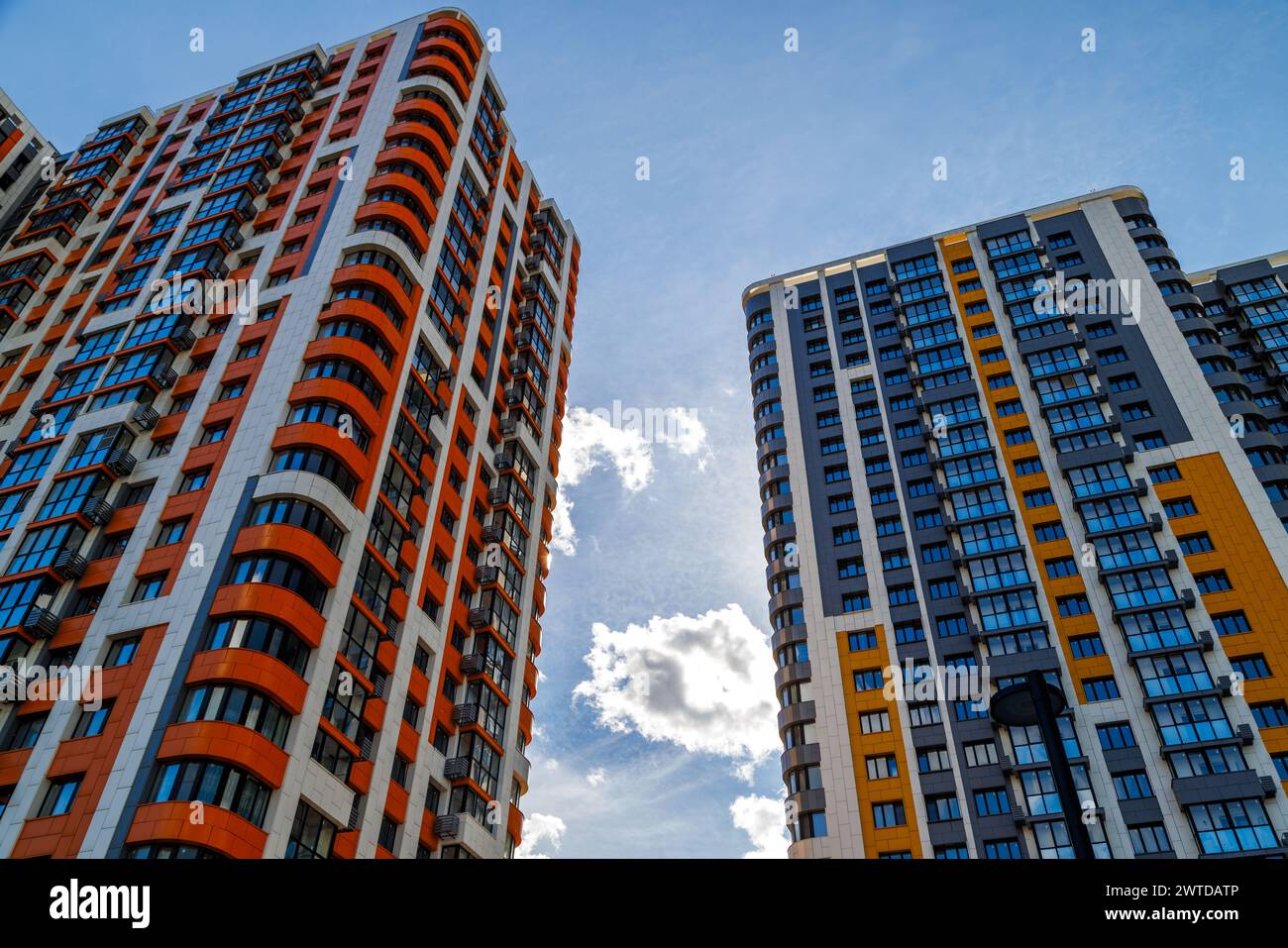 freshly built high rise apartment buildings on blue sky background with ...